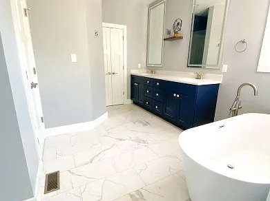 Elegant bathroom with freestanding tub and double vanity by Beiler & Co custom home builders in Winchester Virginia