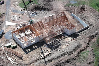 Custom home construction showing framing stage and quality craftsmanship