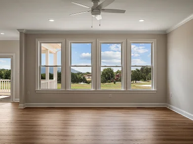 Bright living room with large windows and hardwood flooring in a custom home by Beiler & Co Winchester VA
